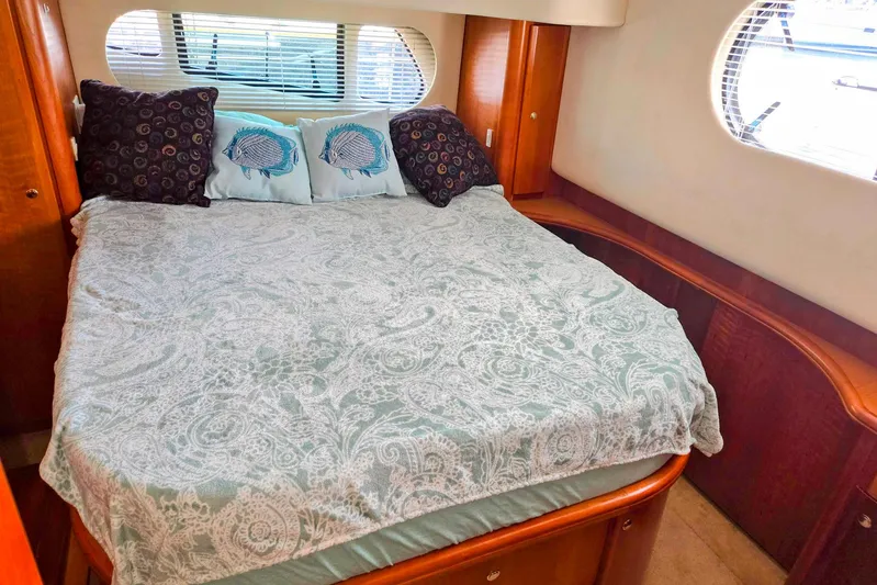  Yacht Photos Pics Luxurious bedroom interior of 2003 Silverton 392 Motor Yacht with elegant bedding and pillows.