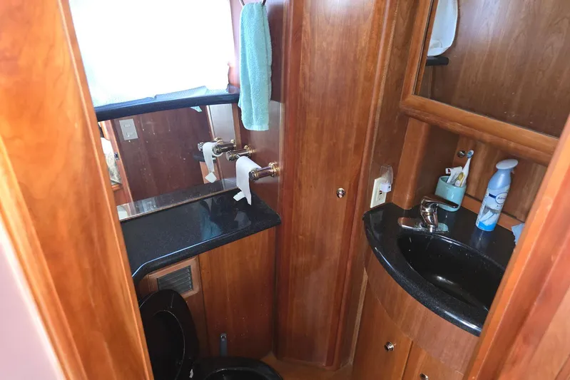  Yacht Photos Pics Luxurious 2003 Silverton 392 Motor Yacht bathroom with wood accents and modern amenities.