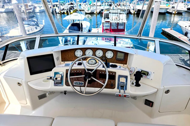  Yacht Photos Pics Helm of 2003 Silverton 392 Motor Yacht with marina view, featuring navigation instruments and controls.