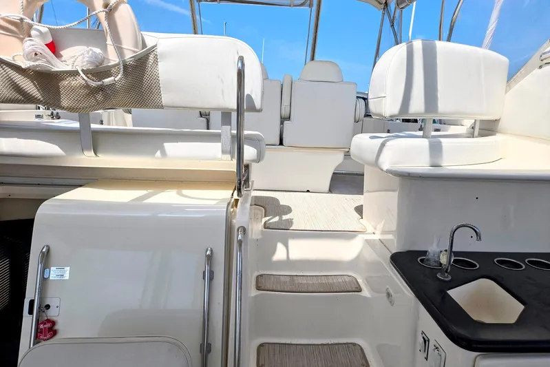  Yacht Photos Pics 2003 Silverton 392 Motor Yacht interior with seating and sink, under clear blue sky.