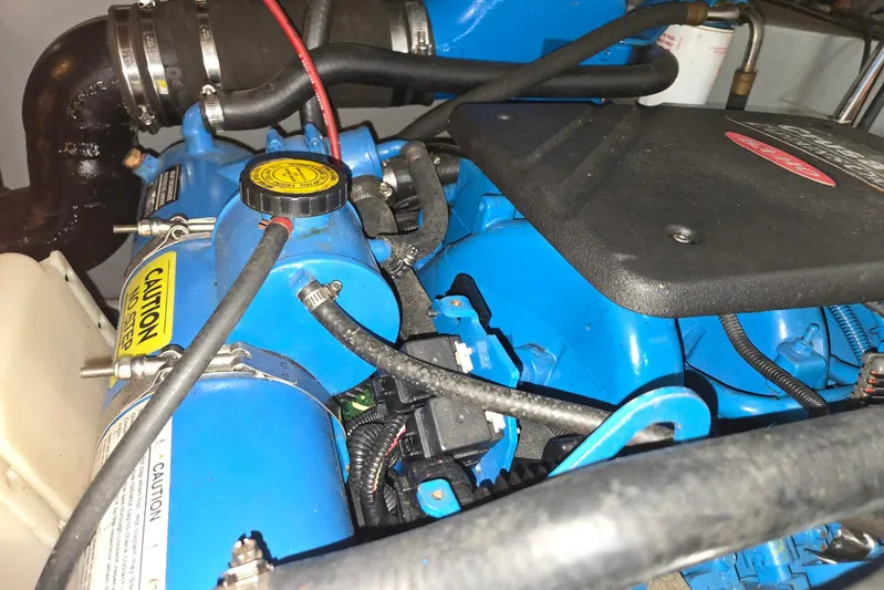  Yacht Photos Pics Engine compartment of a 2003 Silverton 392 Motor Yacht, featuring blue components and caution labels.