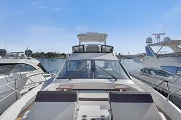 Fly Bridge Motor Yacht Yacht Photos Pics 2018 Cruisers Cantius yacht docked at marina, surrounded by other boats.