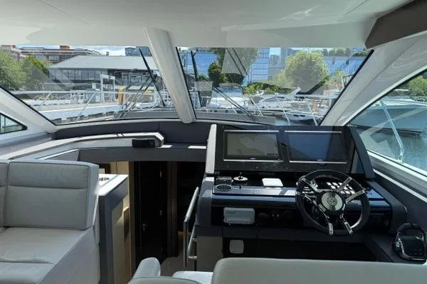 Fly Bridge Motor Yacht Yacht Photos Pics 2018 Cruisers Cantius yacht interior with modern helm, navigation screens, and panoramic windows.