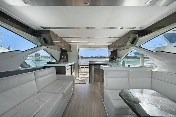 Fly Bridge Motor Yacht Yacht Photos Pics Luxurious interior of a 2018 Cruisers Cantius yacht with modern seating and panoramic windows.