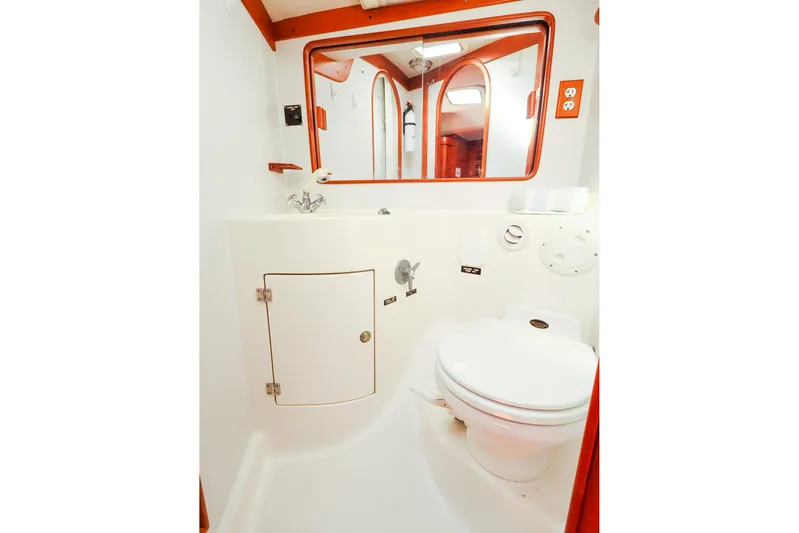 Hamburg II Yacht Photos Pics 2002 J Boats J/46 yacht bathroom with white fixtures and wooden accents.