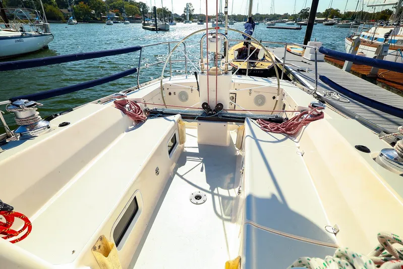 Hamburg II Yacht Photos Pics 2002 J Boats J/46 sailboat cockpit with marina view, featuring winches and ropes.