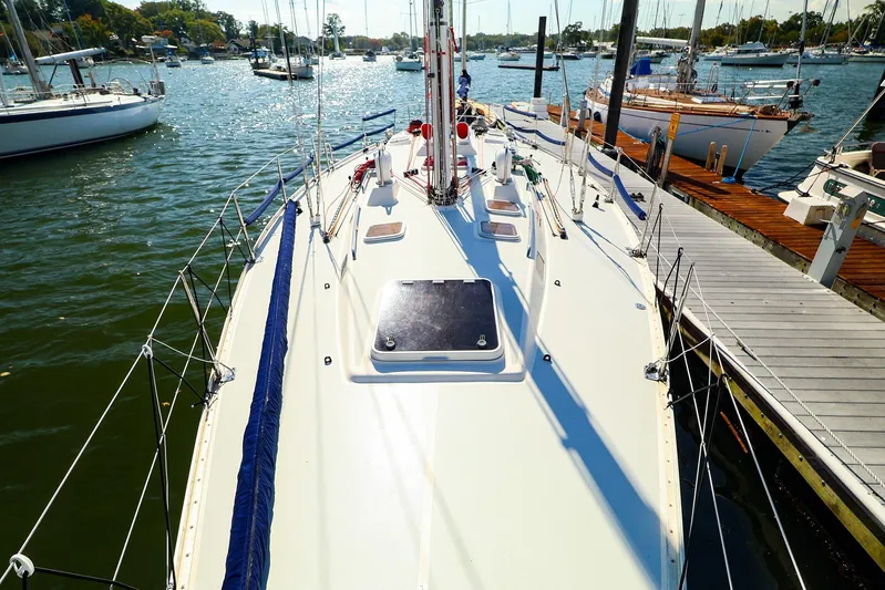 Hamburg II Yacht Photos Pics 2002 J Boats J/46 sailboat docked in a sunny marina, showcasing its sleek deck design.