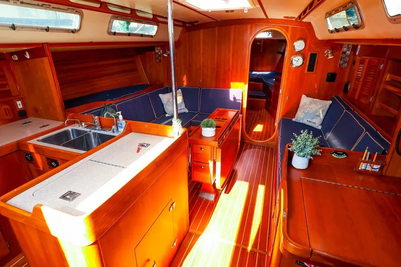 Hamburg II Yacht Photos Pics Luxurious 2002 J Boats J/46 yacht interior with wood finish and cozy seating area.