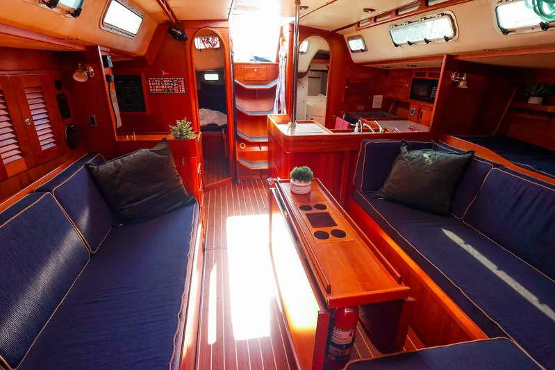 Hamburg II Yacht Photos Pics Luxurious 2002 J Boats J/46 yacht interior with elegant wood finish and cozy seating.