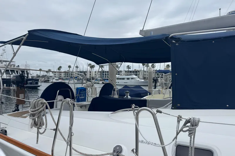 Lumiere Yacht Photos Pics 2007 Beneteau 49 sailboat docked at marina with blue canopy and ropes.