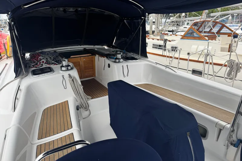 Lumiere Yacht Photos Pics 2007 Beneteau 49 sailboat cockpit with teak flooring and covered seating area.