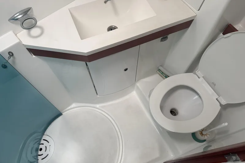 Lumiere Yacht Photos Pics Compact bathroom in a 2007 Beneteau 49 yacht, featuring a sink and toilet.