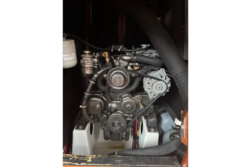 Lumiere Yacht Photos Pics Engine of a 2007 Beneteau 49 sailboat, showcasing mechanical components and hoses.