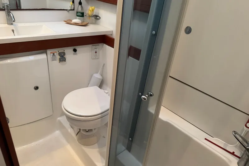 Lumiere Yacht Photos Pics Bathroom interior of a 2007 Beneteau 49 yacht, featuring a toilet and shower.