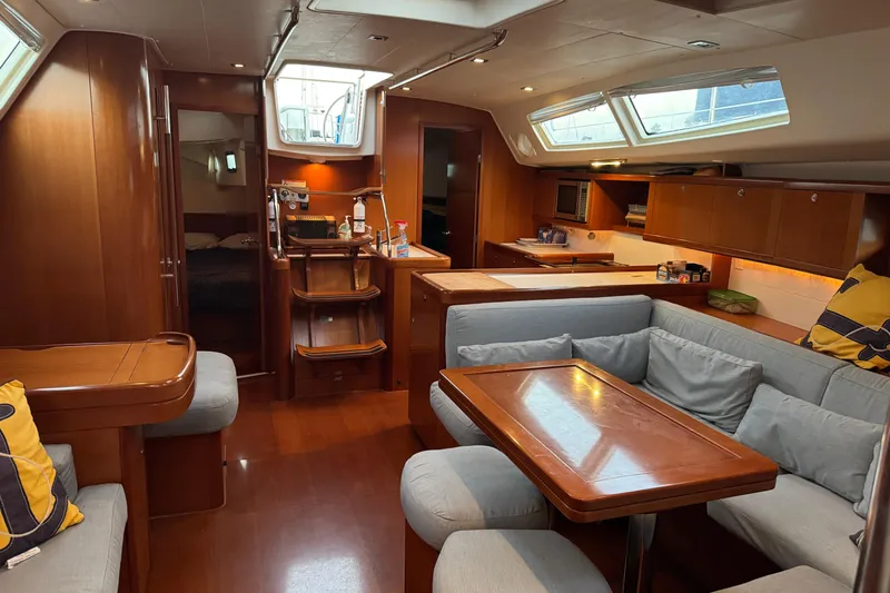 Lumiere Yacht Photos Pics Luxurious interior of 2007 Beneteau 49 yacht with wood finish and cozy seating area.
