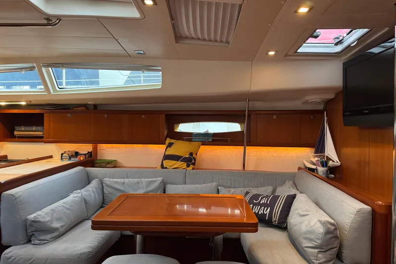 Lumiere Yacht Photos Pics Interior of 2007 Beneteau 49 yacht with cozy seating and elegant wood finish.