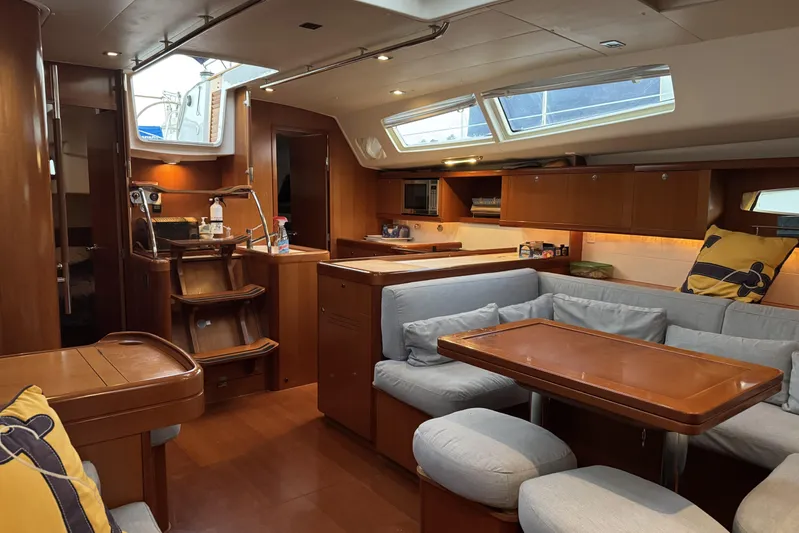 Lumiere Yacht Photos Pics Luxurious interior of 2007 Beneteau 49 yacht with cozy seating and modern kitchen.
