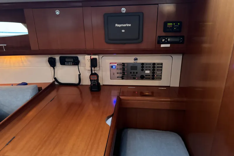 Lumiere Yacht Photos Pics Interior view of a 2007 Beneteau 49 yacht with navigation equipment and control panel.