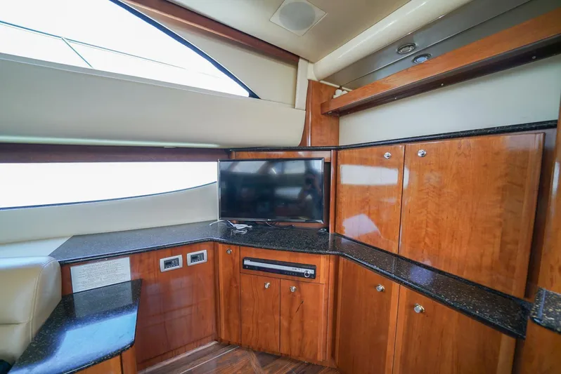 Poseidon's Mistress Yacht Photos Pics Luxurious interior of 2007 Meridian 459 Motor Yacht with TV and wooden cabinetry.