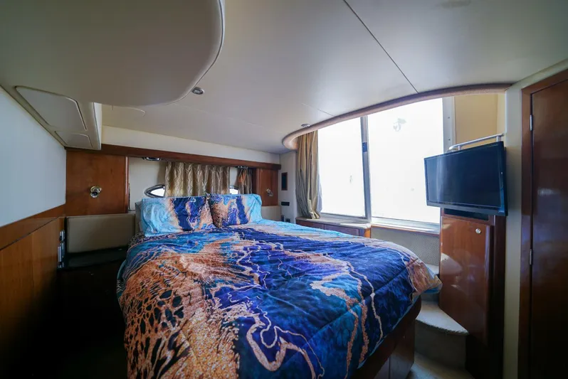 Poseidon's Mistress Yacht Photos Pics Luxurious bedroom in a 2007 Meridian 459 Motor Yacht with vibrant bedding.
