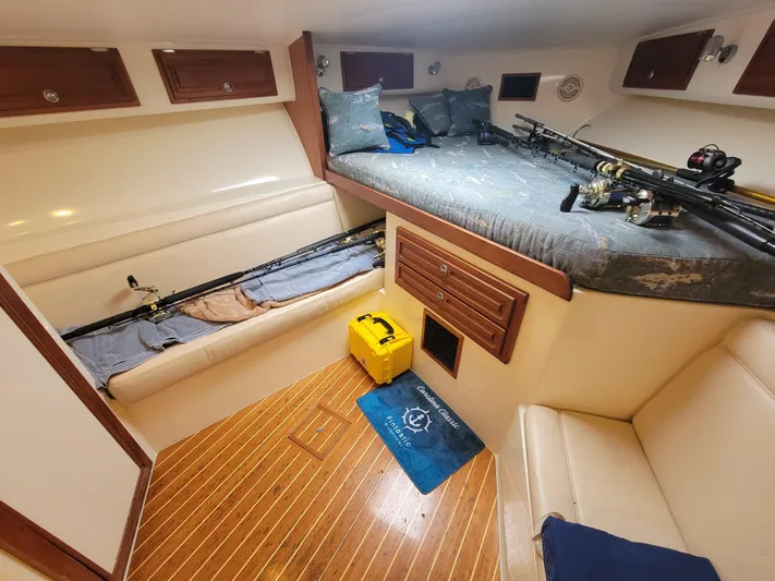  Yacht Photos Pics Interior of 2006 Carolina Classic 32 Express boat with fishing rods and cozy seating.