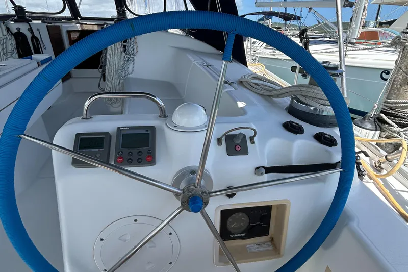 Pau Hana Yacht Photos Pics Steering wheel and controls of a 2007 Beneteau Cyclades 50.3 sailboat.