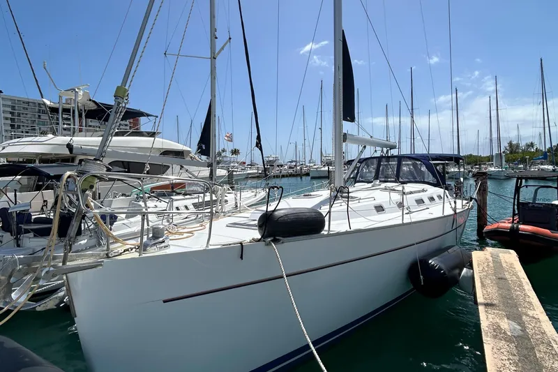 Pau Hana Yacht Photos Pics 2007 Beneteau Cyclades 50.3 sailboat docked in a sunny marina.