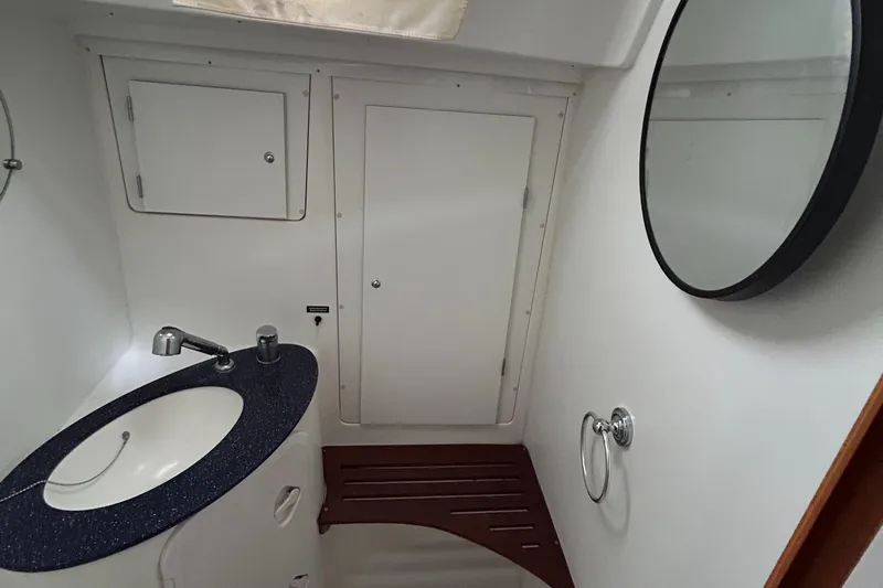 Pau Hana Yacht Photos Pics Bathroom interior of 2007 Beneteau Cyclades 50.3 yacht with sink and mirror.