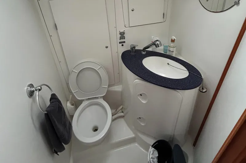 Pau Hana Yacht Photos Pics Compact bathroom in a 2007 Beneteau Cyclades 50.3 yacht, featuring a toilet and sink.