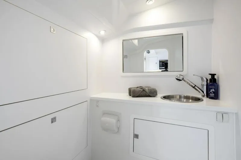 Svg II Yacht Photos Pics 2016 VanDutch CRUISER bathroom with modern sink, mirror, and storage cabinets.