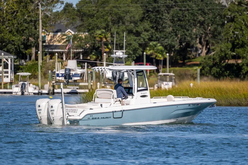  Yacht Photos Pics 2024 Sea Hunt Escape 28 boat cruising on a scenic waterway.