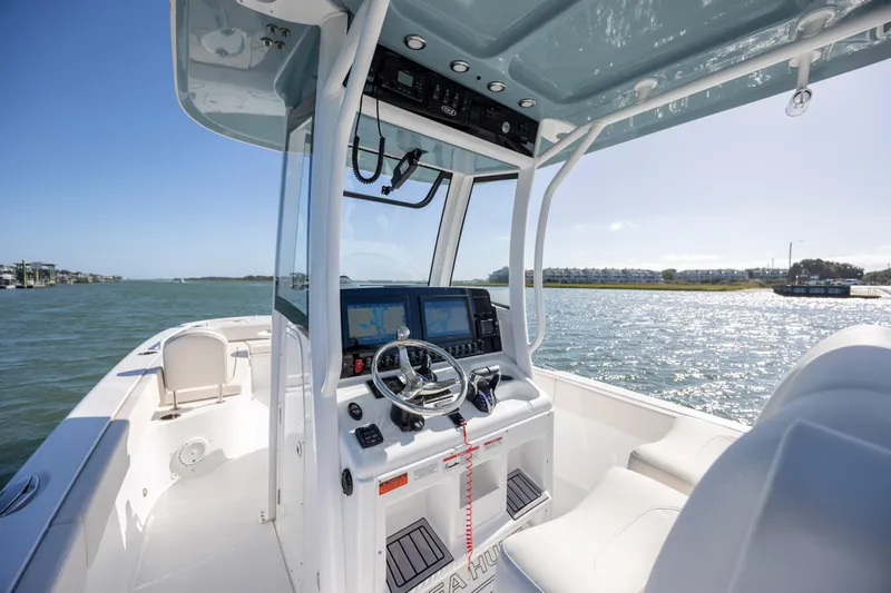  Yacht Photos Pics 2024 Sea Hunt Escape 28 boat interior with modern dashboard and scenic water view.