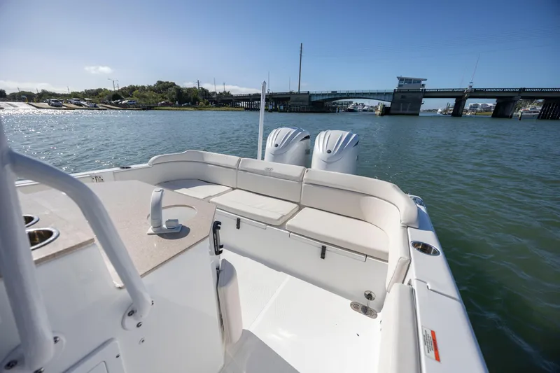  Yacht Photos Pics 2024 Sea Hunt Escape 28 boat with dual engines on a sunny day near a bridge.
