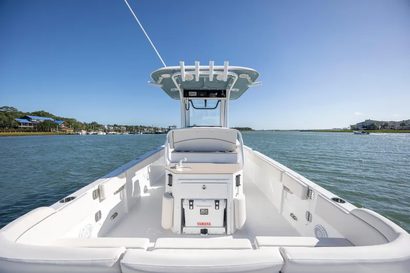  Yacht Photos Pics 2024 Sea Hunt Escape 28 boat on calm water under clear blue sky.