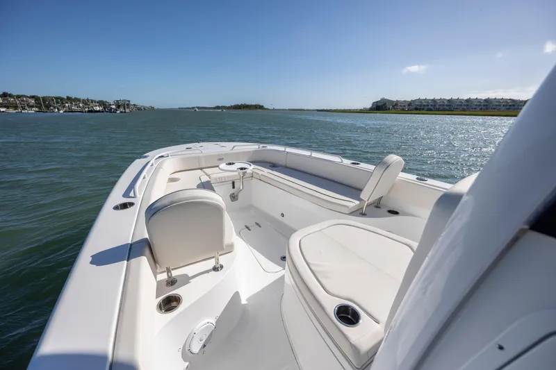  Yacht Photos Pics 2024 Sea Hunt Escape 28 boat on calm water, featuring spacious seating and sleek design.