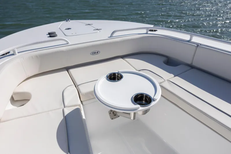  Yacht Photos Pics 2024 Sea Hunt Escape 28 boat interior with cushioned seating and cup holders.