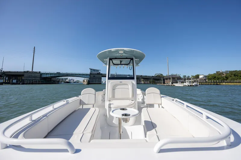  Yacht Photos Pics 2024 Sea Hunt Escape 28 boat on water, featuring spacious seating and clear blue sky.