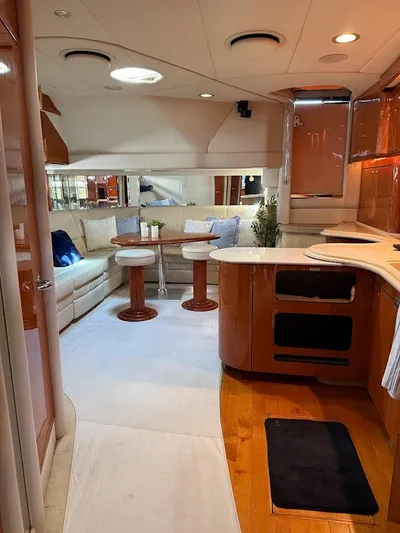  Yacht Photos Pics Luxurious interior of 2000 Sea Ray 510 Sundancer yacht with modern kitchen and cozy seating area.