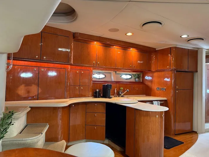  Yacht Photos Pics Luxurious interior of 2000 Sea Ray 510 Sundancer yacht with polished wood cabinetry.