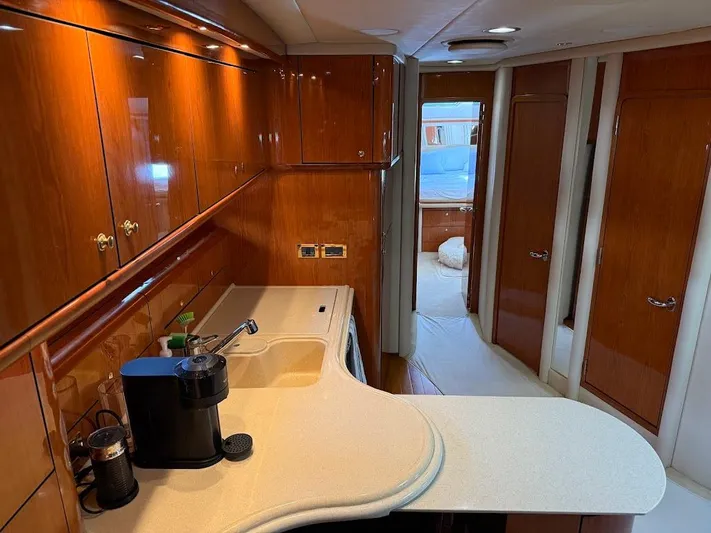  Yacht Photos Pics Luxurious interior of 2000 Sea Ray 510 Sundancer yacht with polished wood cabinetry.