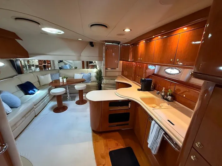  Yacht Photos Pics Luxurious interior of 2000 Sea Ray 510 Sundancer yacht with elegant seating and modern kitchen.