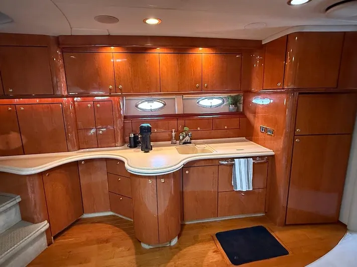  Yacht Photos Pics Luxurious kitchen interior of 2000 Sea Ray 510 Sundancer yacht with wooden cabinetry.