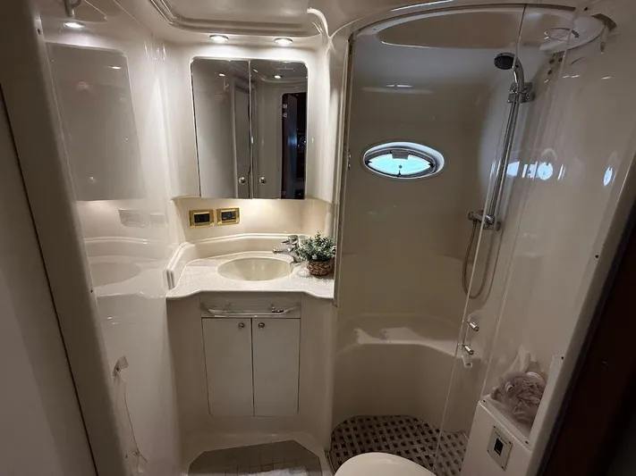  Yacht Photos Pics Luxurious bathroom in 2000 Sea Ray 510 Sundancer yacht, featuring elegant fixtures and a porthole window.