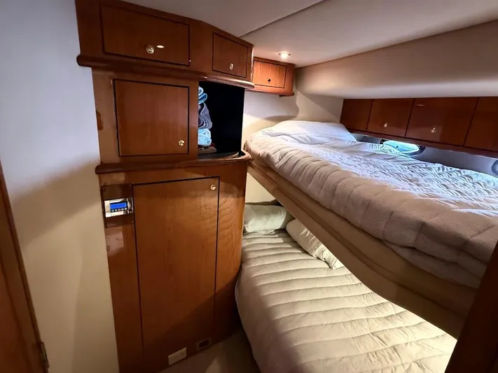  Yacht Photos Pics Cabin interior of 2000 Sea Ray 510 Sundancer with wooden cabinets and bunk beds.