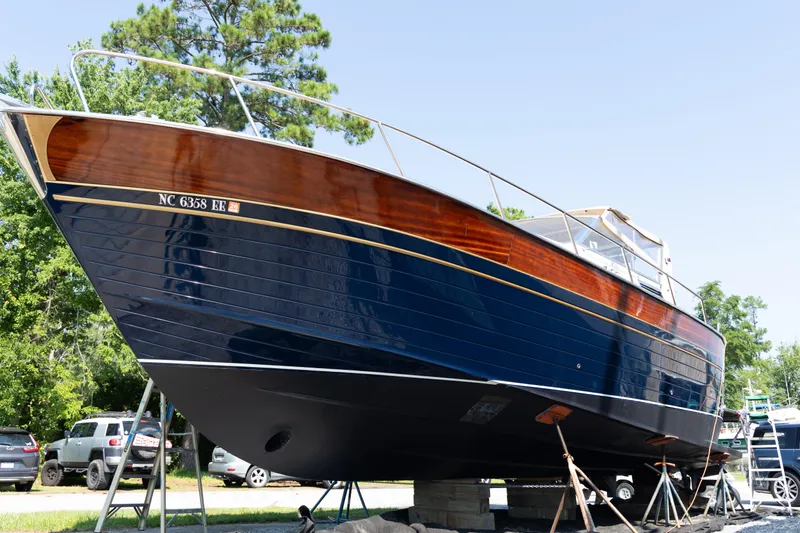 A'maure Yacht Photos Pics 2001 Apreamare 11 boat on land, showcasing sleek design and polished wood finish.