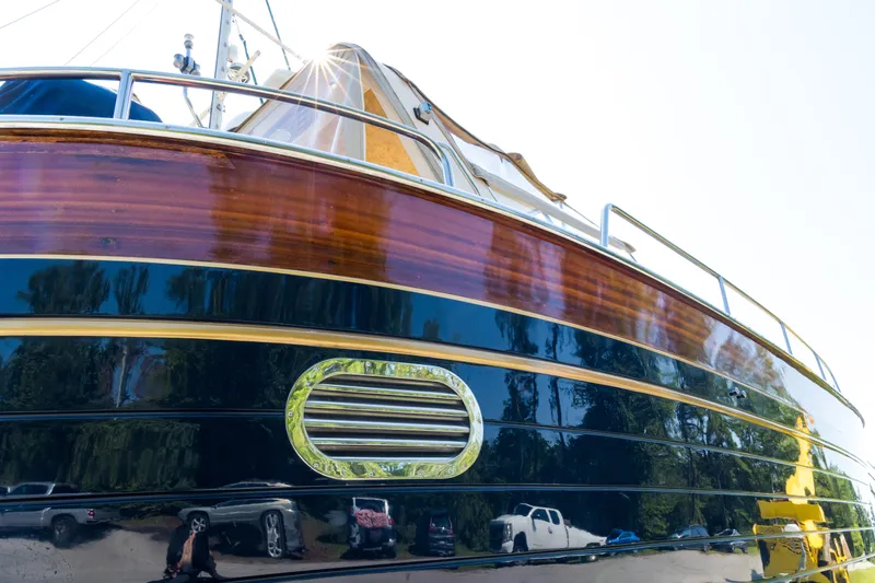 A'maure Yacht Photos Pics 2001 Apreamare 11 yacht with polished wooden and metal exterior, reflecting surroundings.