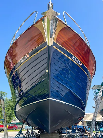 A'maure Yacht Photos Pics 2001 Apreamare 11 boat with polished wood and blue hull, displayed on stands.