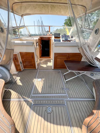 A'maure Yacht Photos Pics Interior of a 2001 Apreamare 11 boat with wooden flooring and seating area.