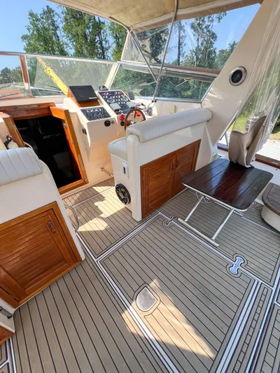 A'maure Yacht Photos Pics Interior of 2001 Apreamare 11 yacht with wooden accents and modern controls.