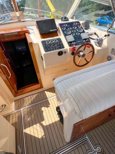 A'maure Yacht Photos Pics 2001 Apreamare 11 boat cockpit with steering wheel, control panel, and seating.